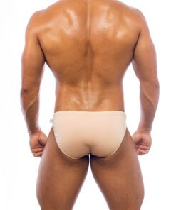 Men's swimwear, briefs style, worn by a man, back view, sand color background.